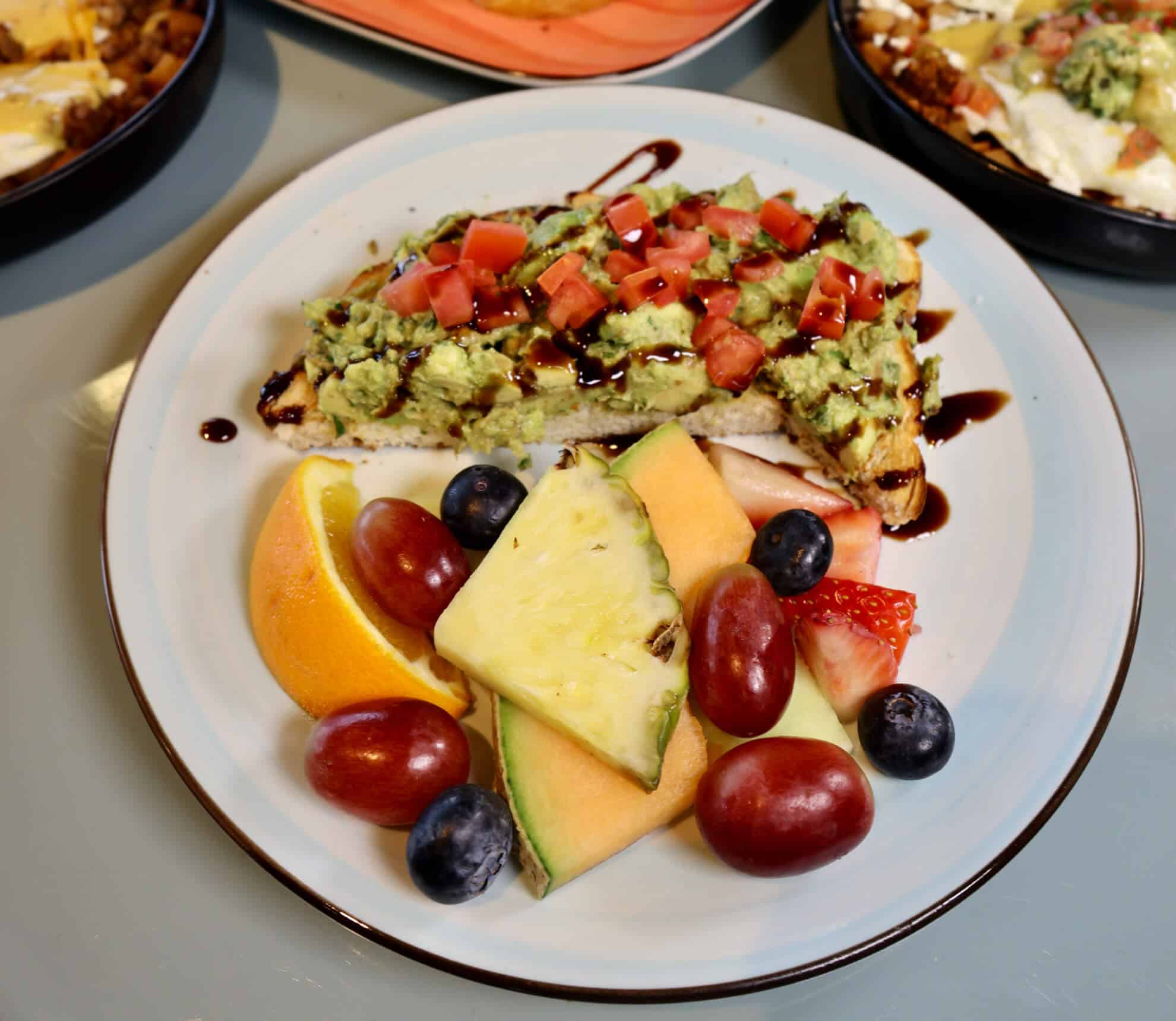 Avocado Toast with balsamic glaze and fresh fruit at The Morning Post